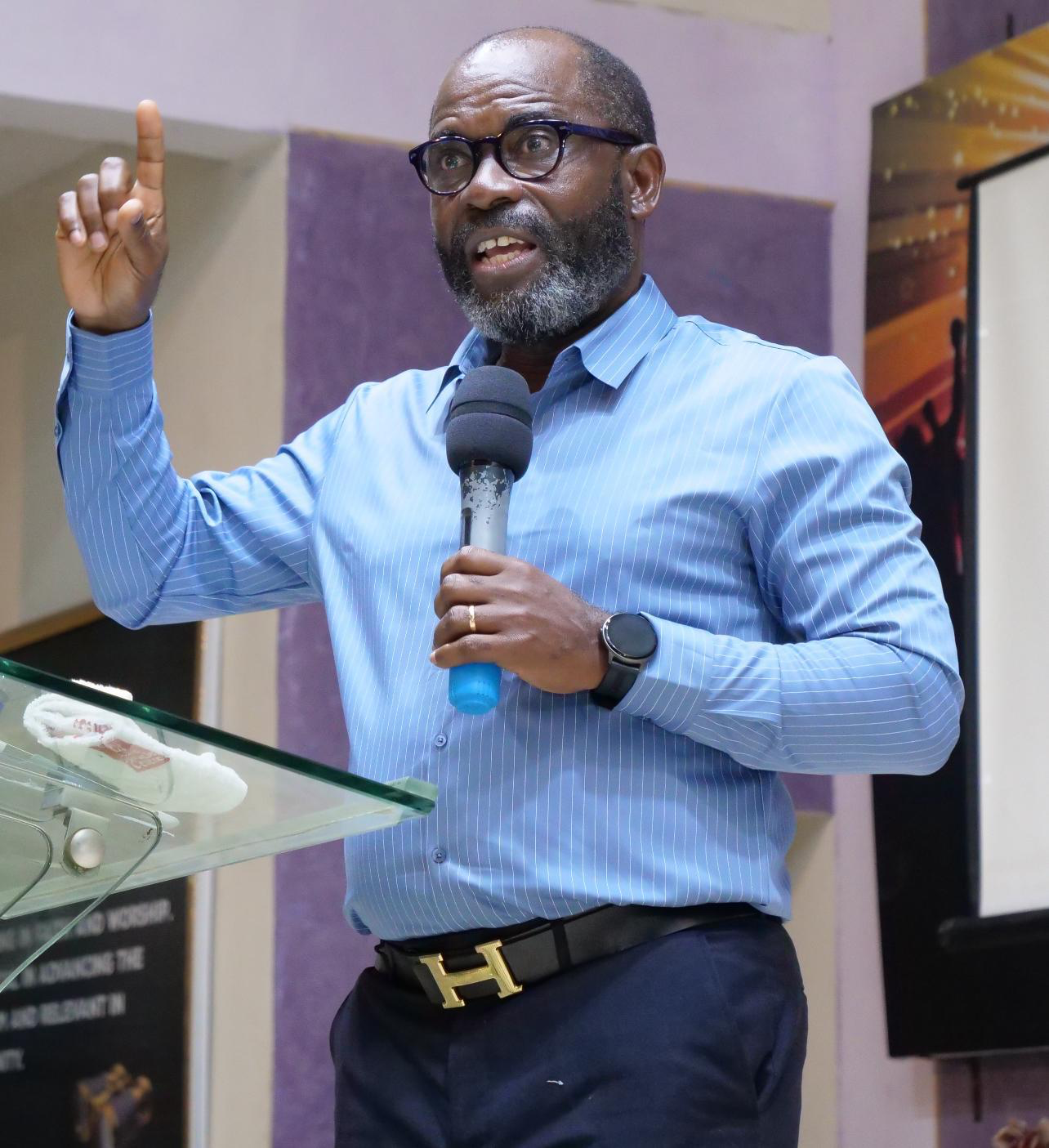 Kingsley K. O. Alfred speaking while holding a microphone
